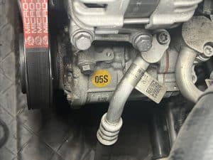 Failed car AC compressor with oil leak around the clutch